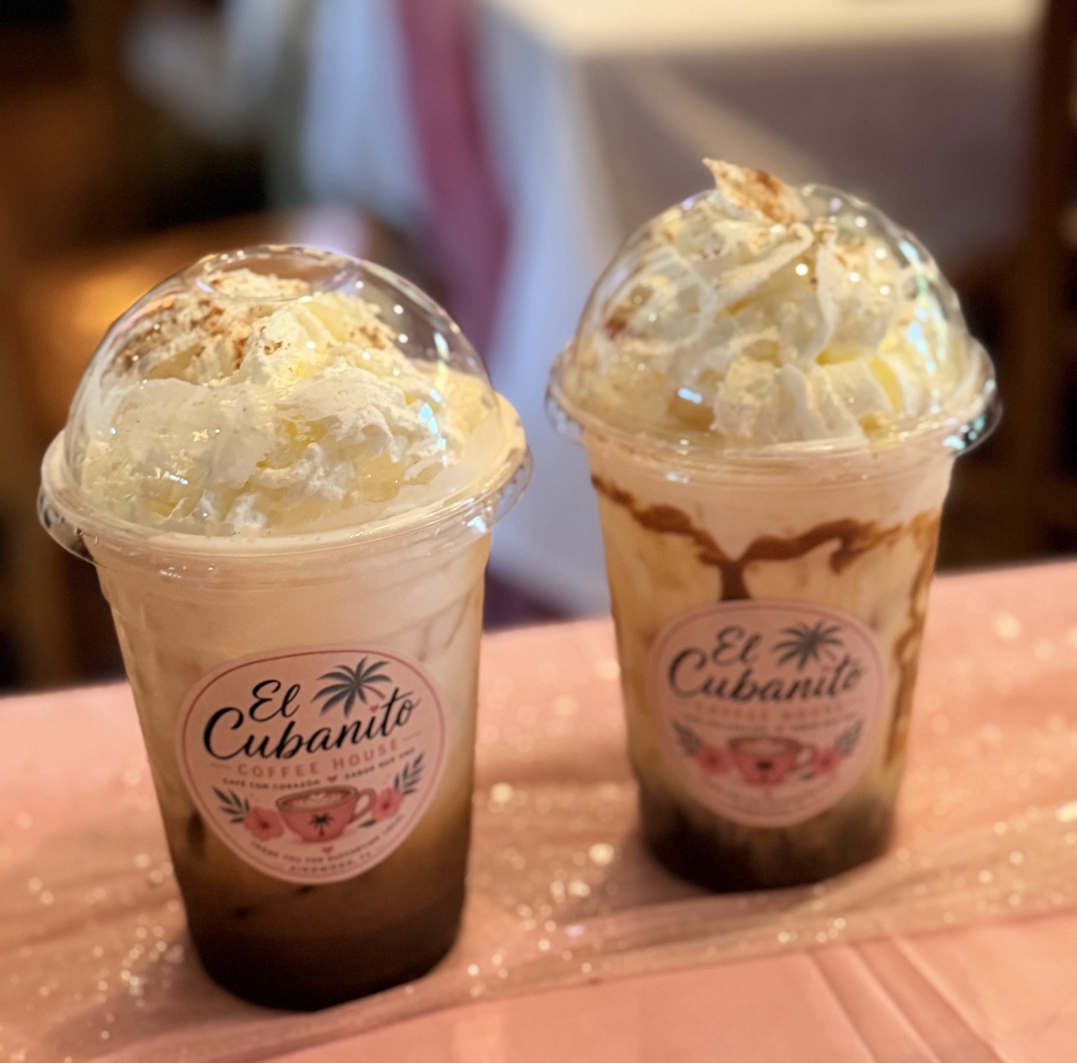 Two blended iced drinks topped with whipped cream