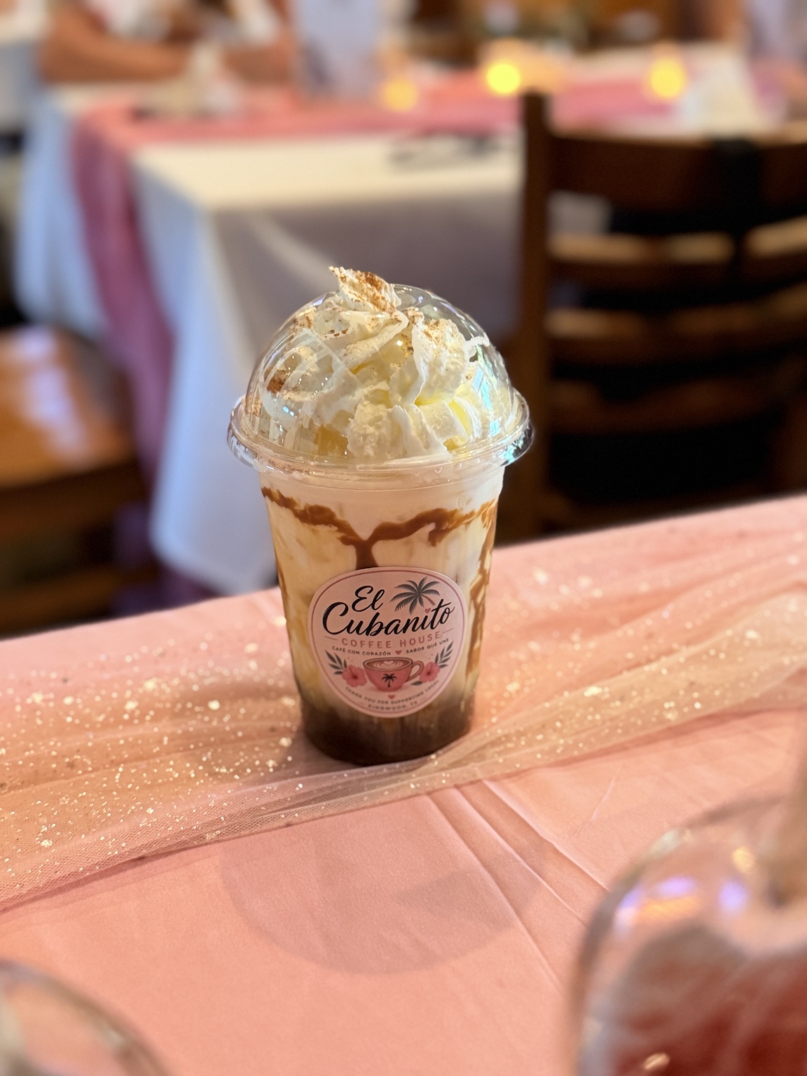 A pumpkin spice iced coffee topped with whipped cream and cinnamon